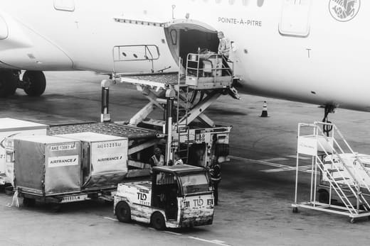 Ground crew loading air cargo into a jet