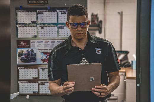 A warehouse supervisor checking shift schedules