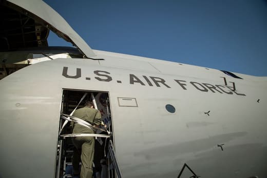 An airman boarding an Air Force transport plane, for supply chain degrees for military and veterans