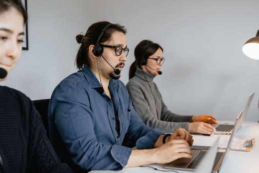 Logistics coordinators in headsets, for freight broker pay